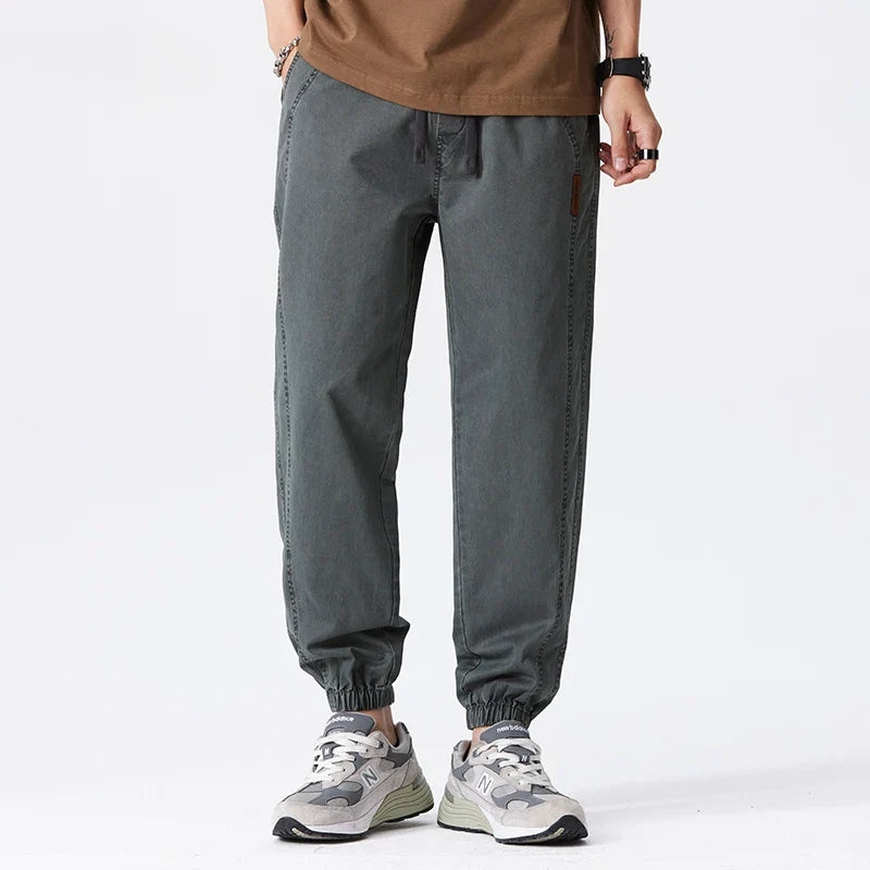 Full-length view of men's relaxed joggers with drawstring waist and tapered leg design