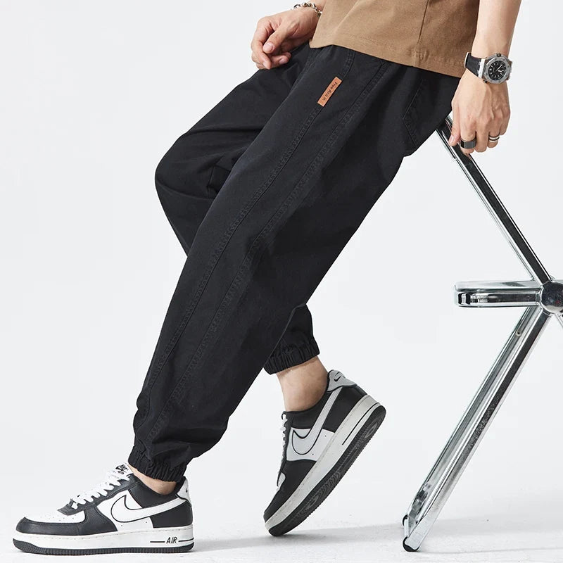 Detail shot of adjustable drawstring waistband on men's casual stretch joggers