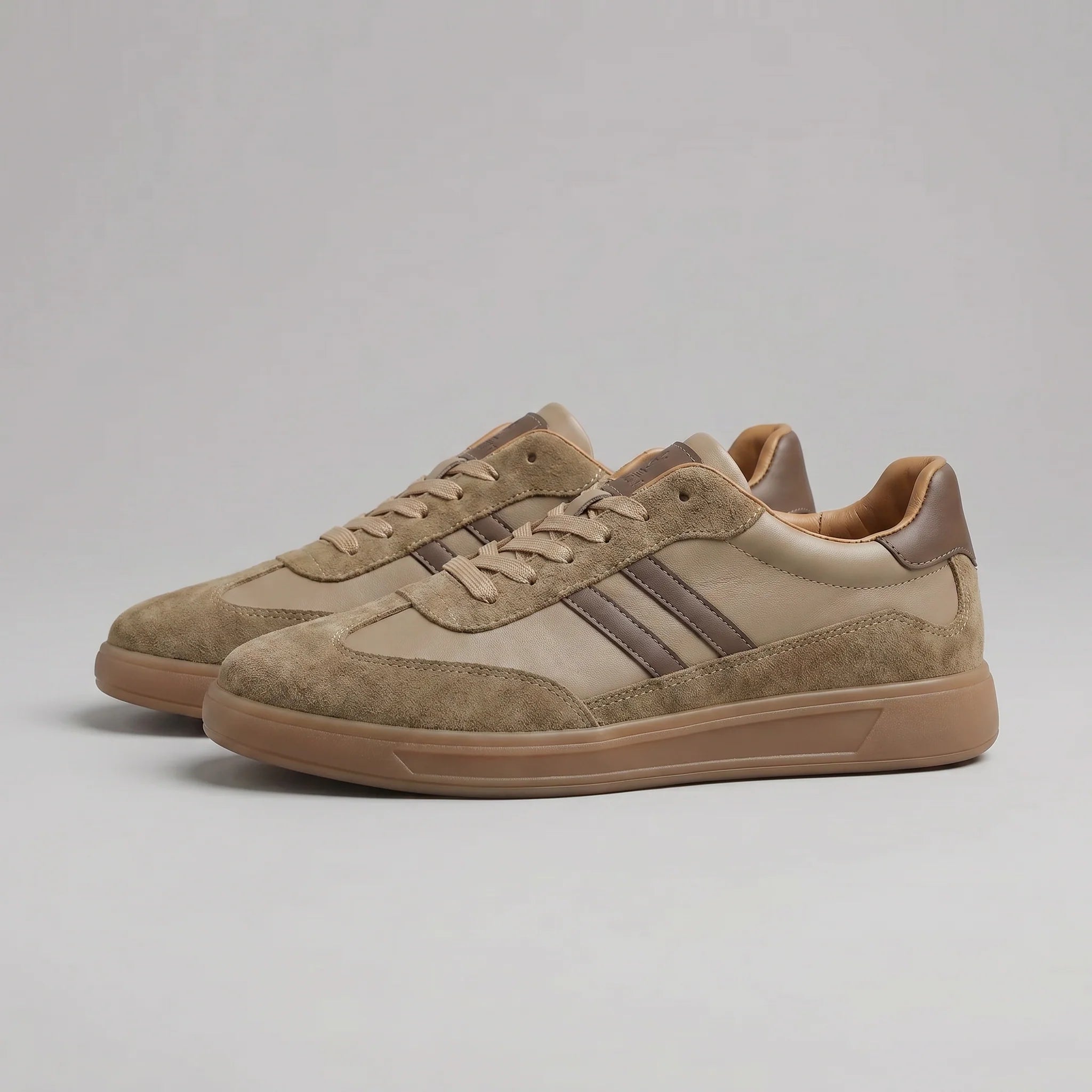 Detail of men's retro trainers showing suede overlays and navy heel counter