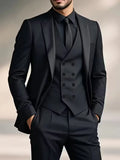 Man wearing a black three-piece suit with double-breasted waistcoat and matching blazer and trousers