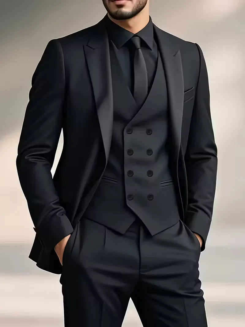 Man wearing a black three-piece suit with double-breasted waistcoat and matching blazer and trousers