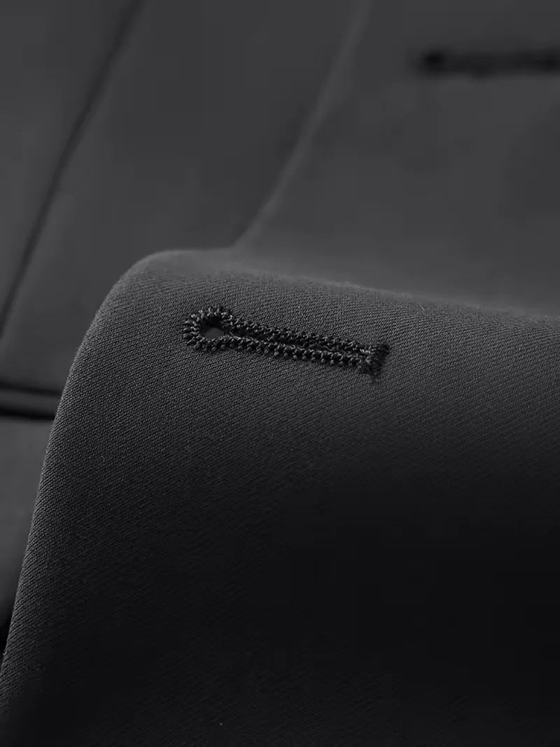 Detail of suit trousers with flat front and mid-rise waistband