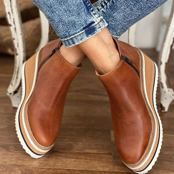 Women's ankle boots in beige featuring raised sole and secure zip closure for everyday wear
