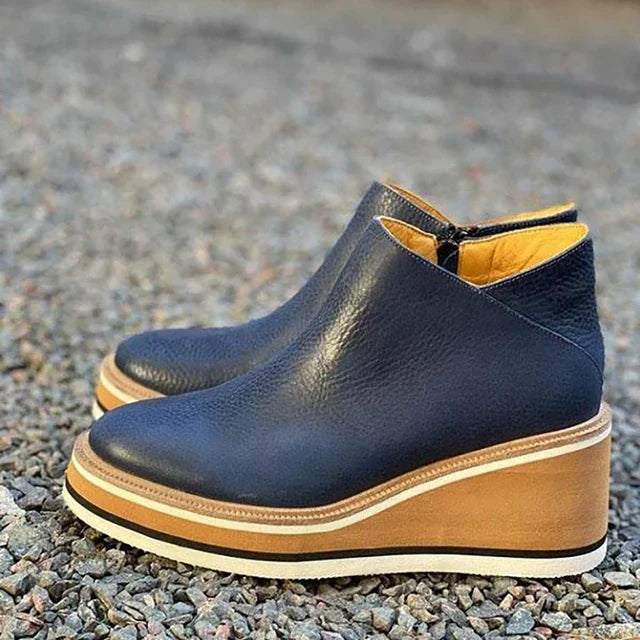 Detail of women's ankle boots showing structured design and grounded sole construction