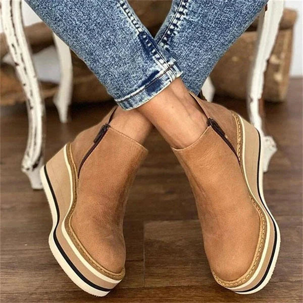 Full view of women's ankle boots in brown with side zip and raised platform sole