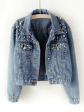 Women's cropped denim jacket with scattered pearl embellishments across collar and shoulders in light wash blue denim