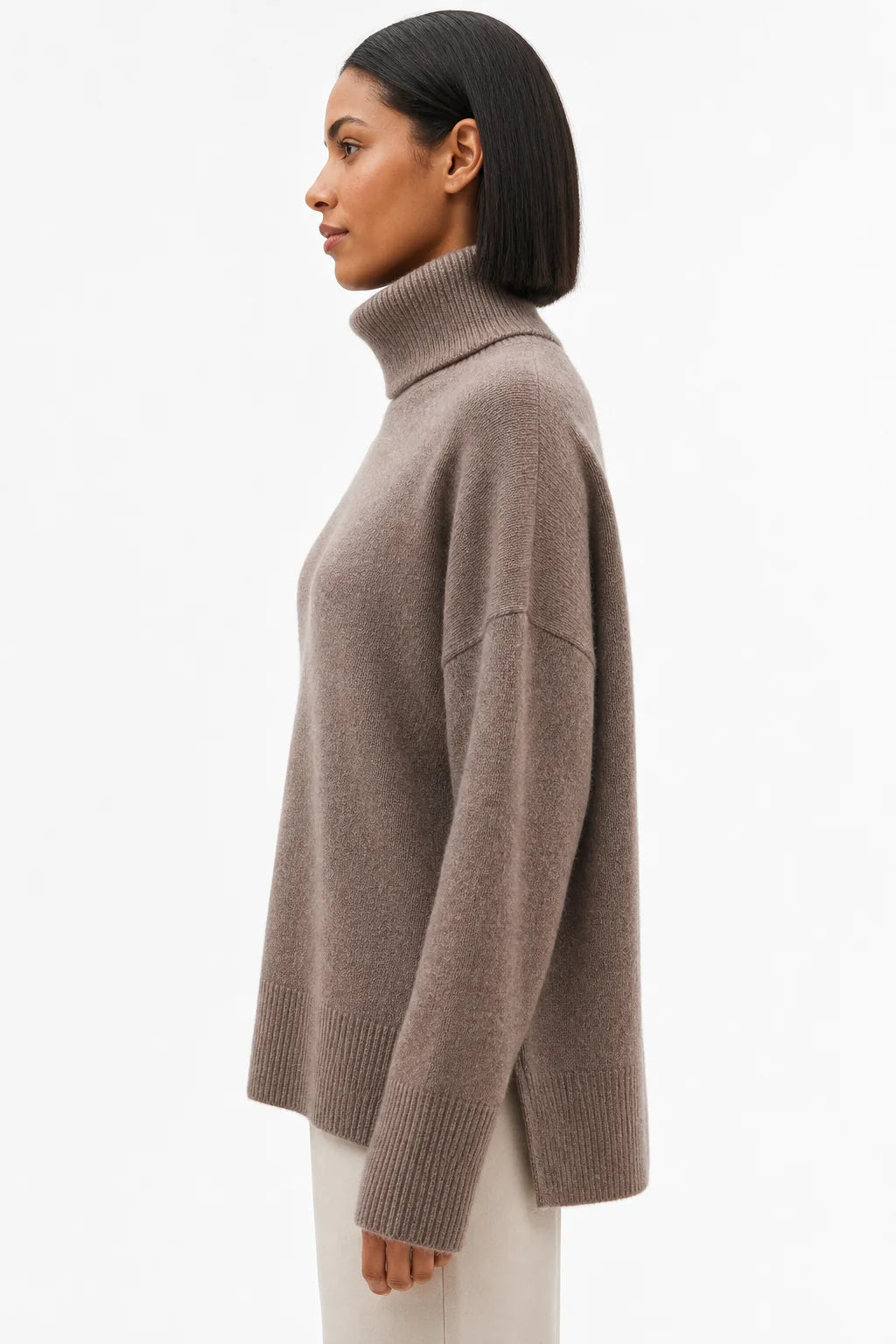 Side angle showing the relaxed drape and ribbed detailing of the merino turtleneck jumper