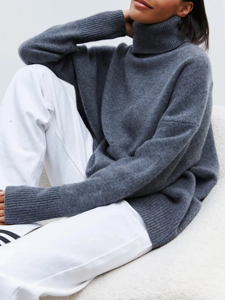 Back view of the relaxed-fit turtleneck jumper in blue with oversized silhouette and ribbed hem