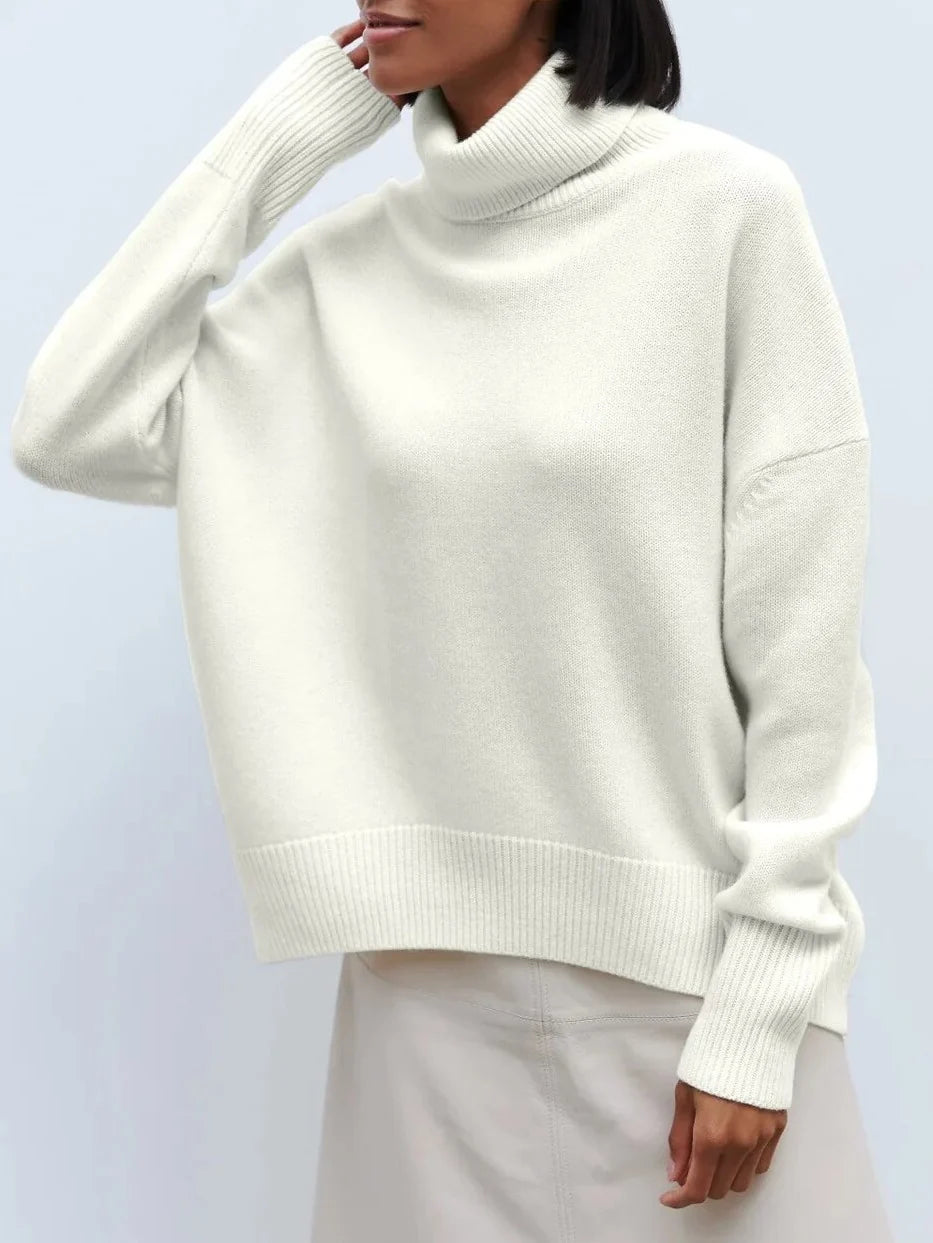 Detail of the khaki turtleneck jumper showing soft knit construction and structured roll neck