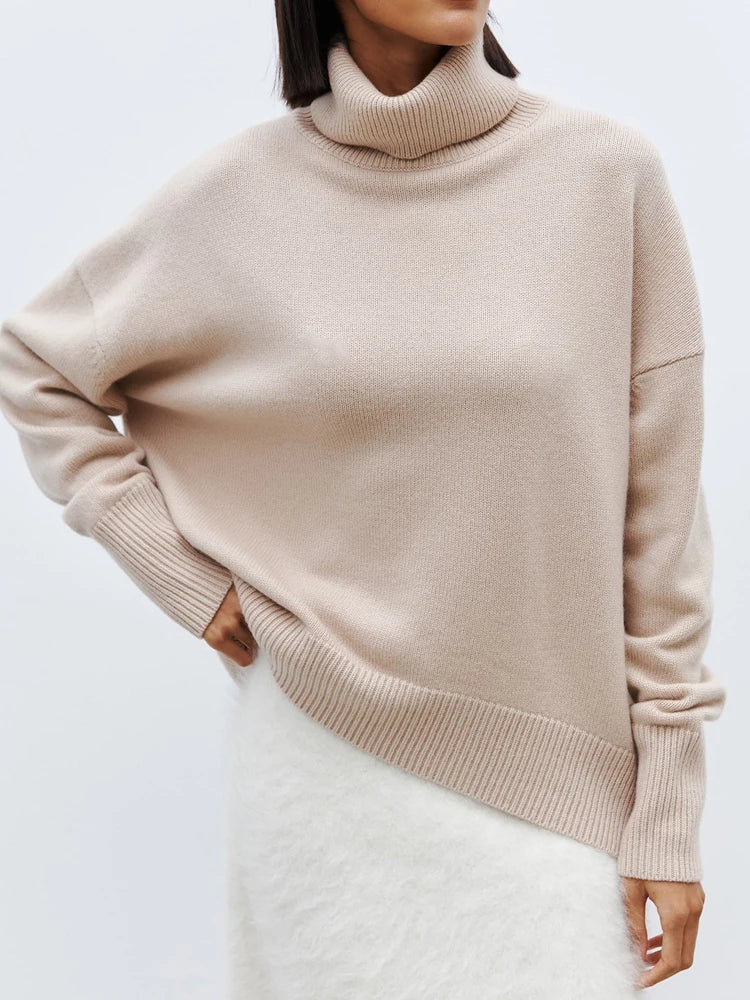 Woman wearing the blue oversized merino turtleneck paired with denim for casual layered style