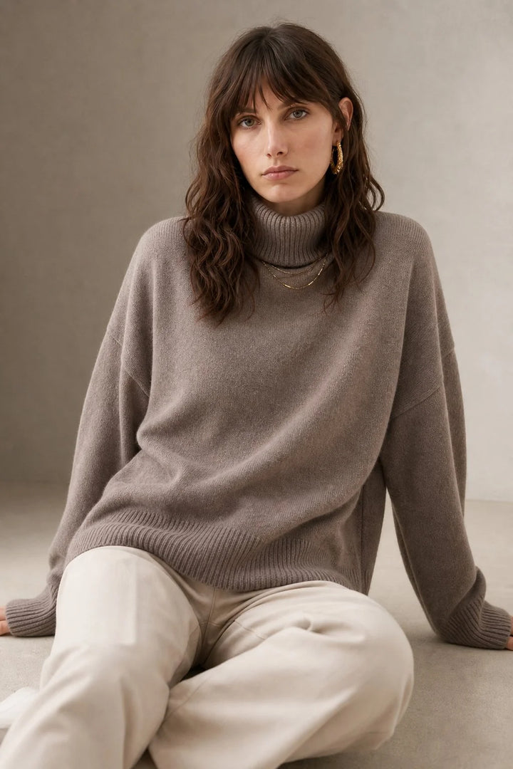 Detail shot of the ribbed cuffs and hem on the merino turtleneck jumper in slate blue