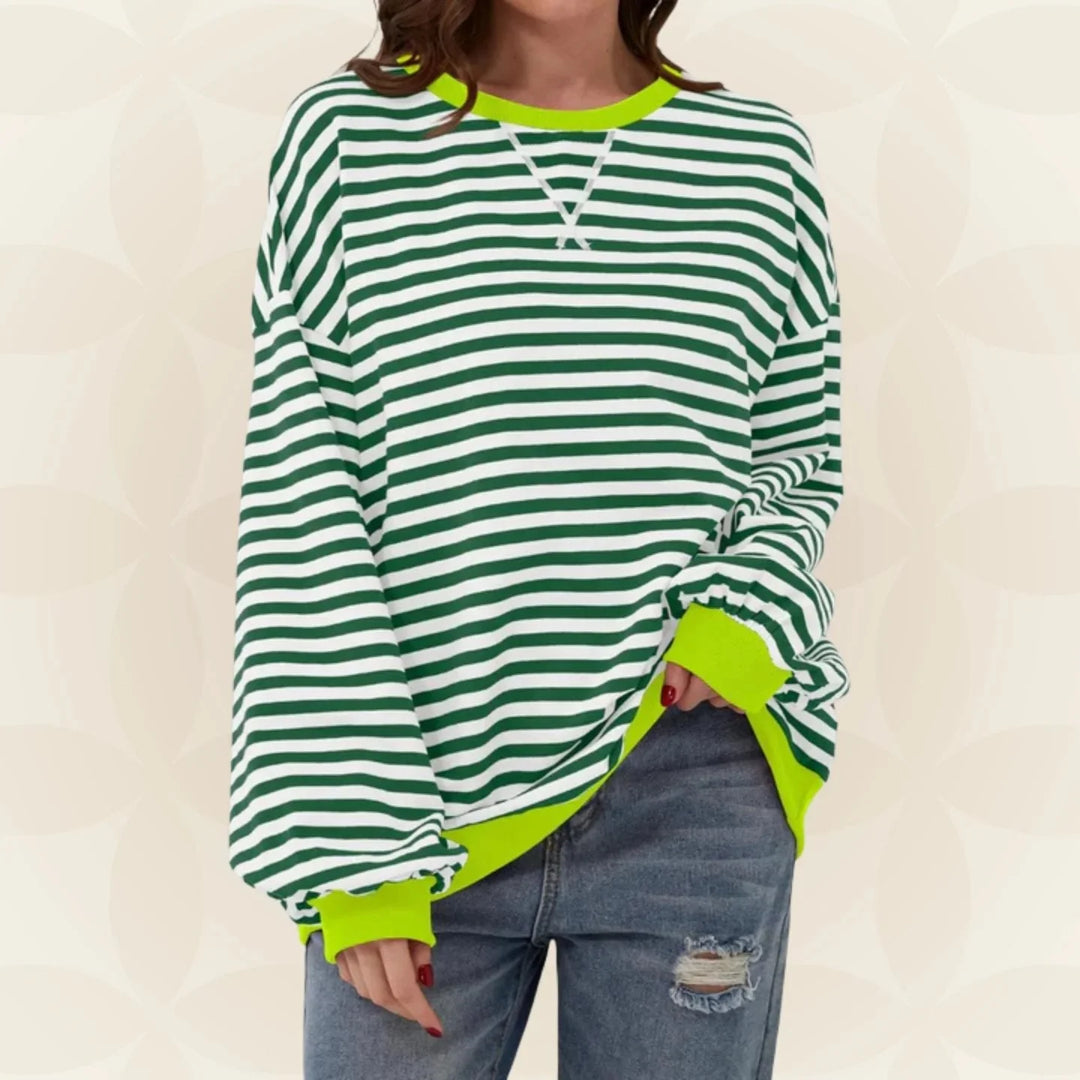 Woman wearing green and white striped oversized sweatshirt with neon yellow contrast trim and relaxed fit