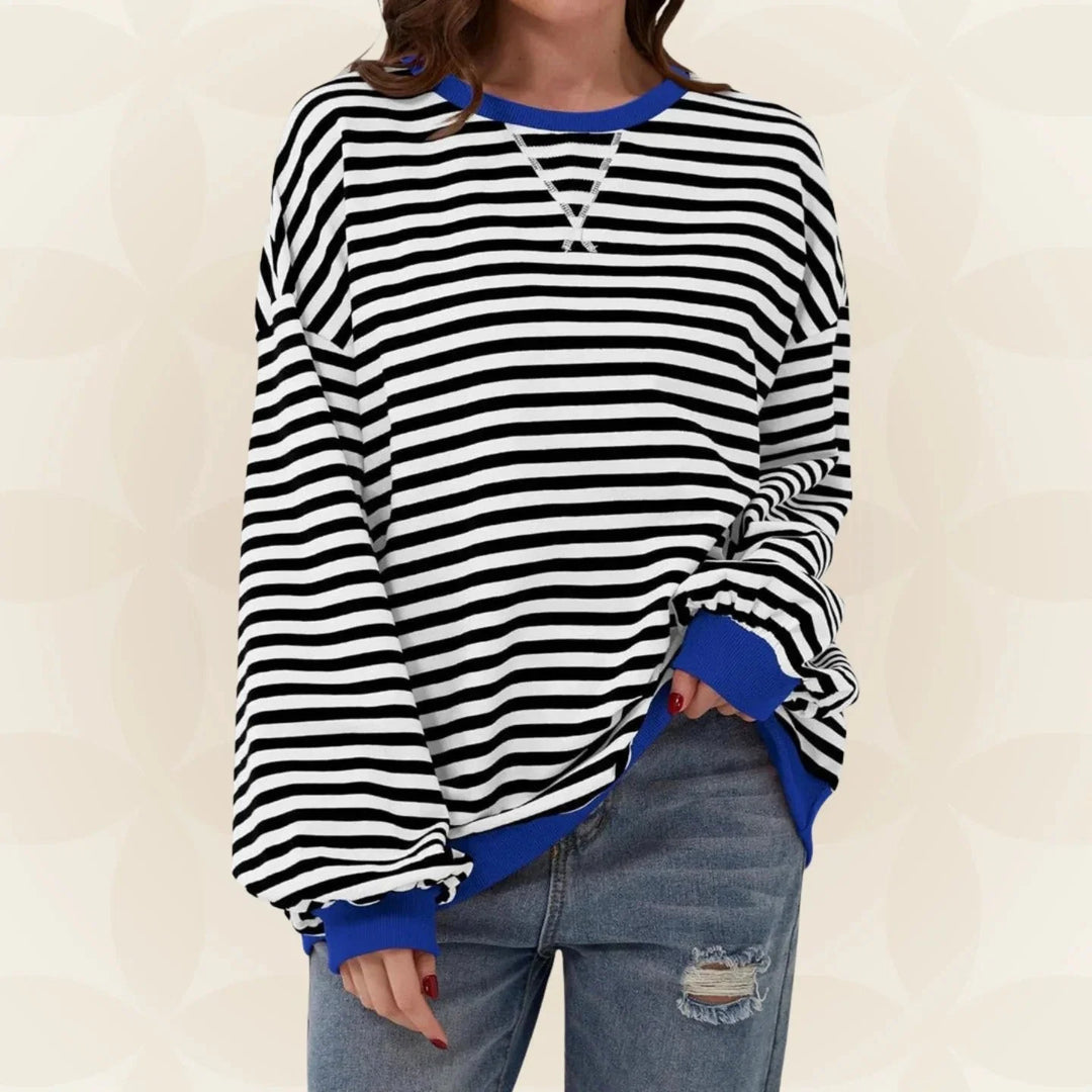 Close-up view of oversized striped sweatshirt showing horizontal stripe pattern and contrast ribbed cuffs