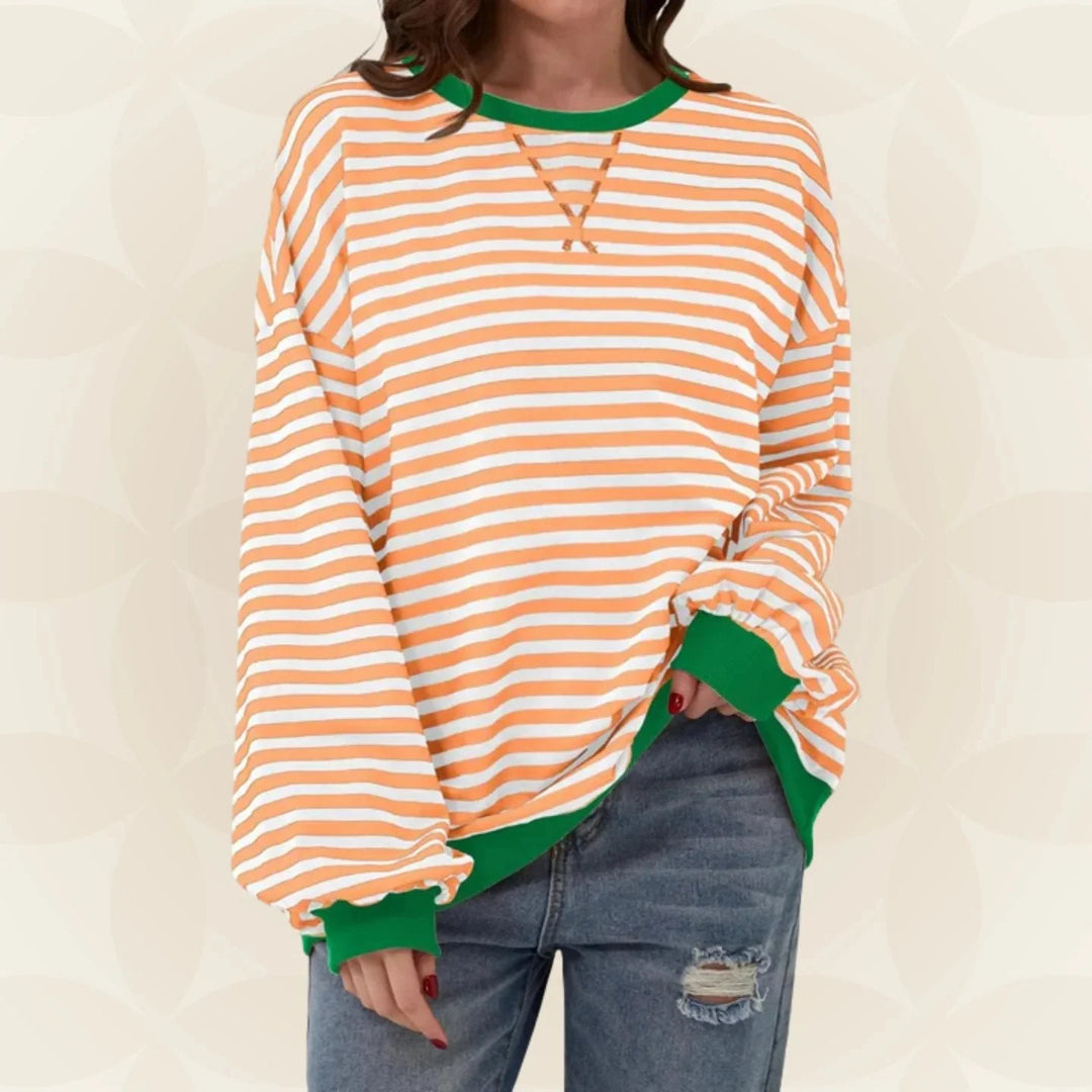 Black and white striped oversized sweatshirt with contrast trim worn with casual denim jeans
