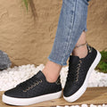 Women's quilted trainers with lace-up closure and white platform sole worn with cropped jeans