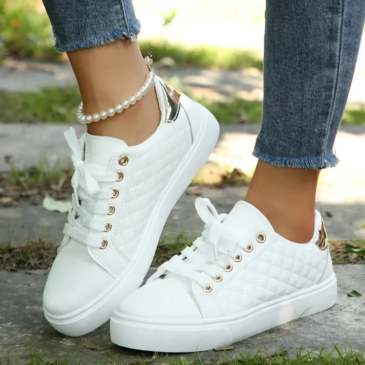 Close-up of women's quilted trainers showing diamond-stitch detailing and rose-gold eyelets on textured upper