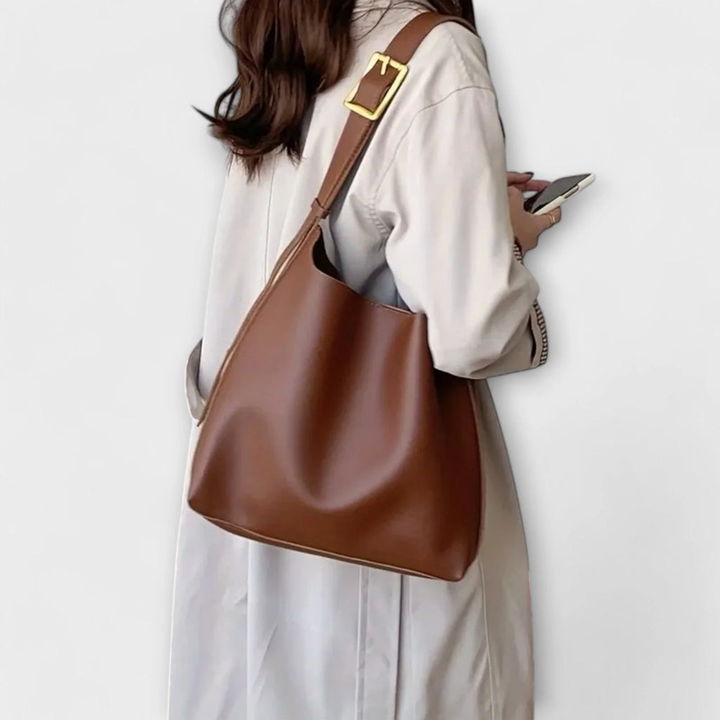 Slouchy shoulder bag showing curved top edge and relaxed silhouette structure