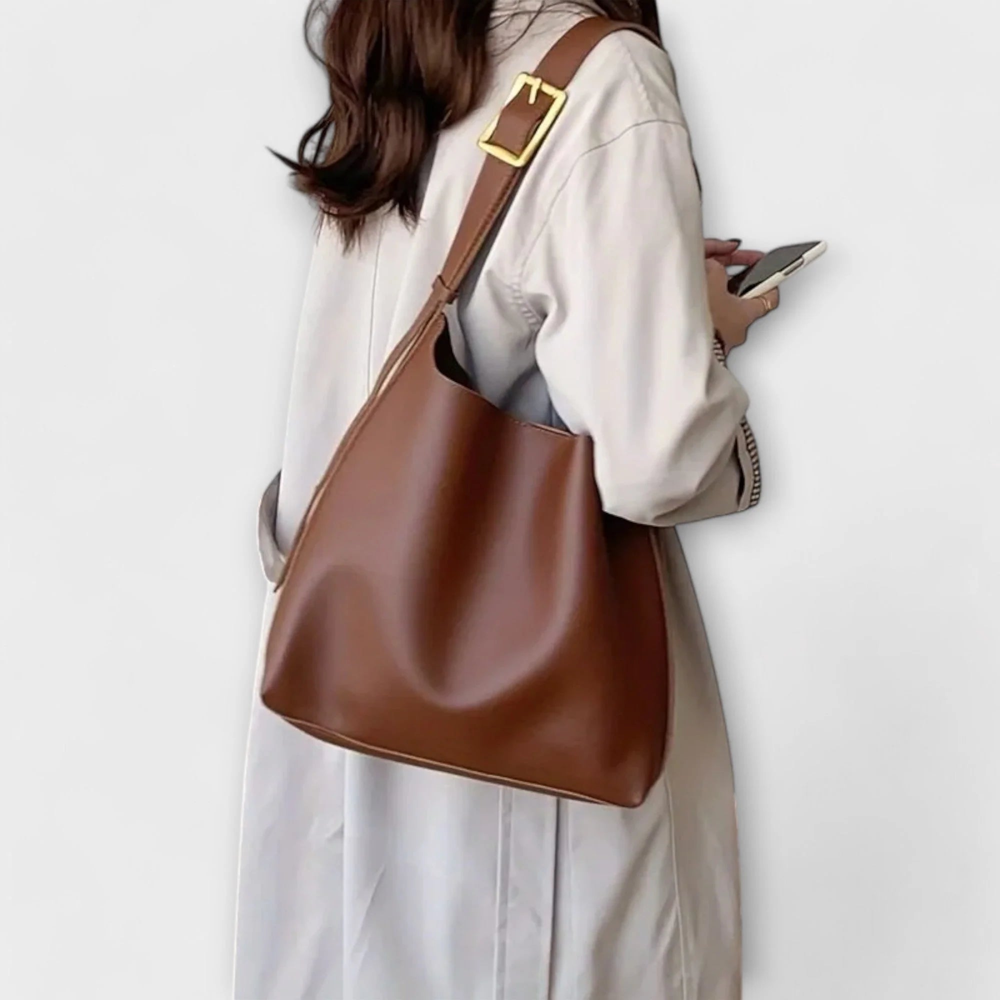 Slouchy shoulder bag showing curved top edge and relaxed silhouette structure