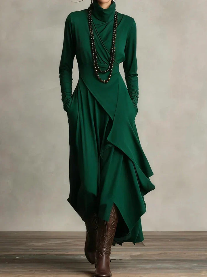 Side angle of draped maxi dress highlighting layered asymmetric design and knit fabric