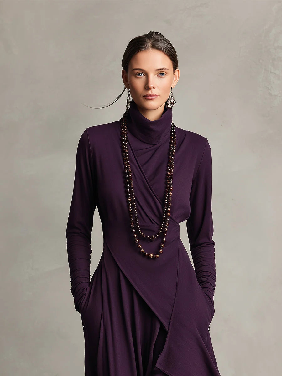 Back view of asymmetric maxi dress showing draped panels and long sleeves