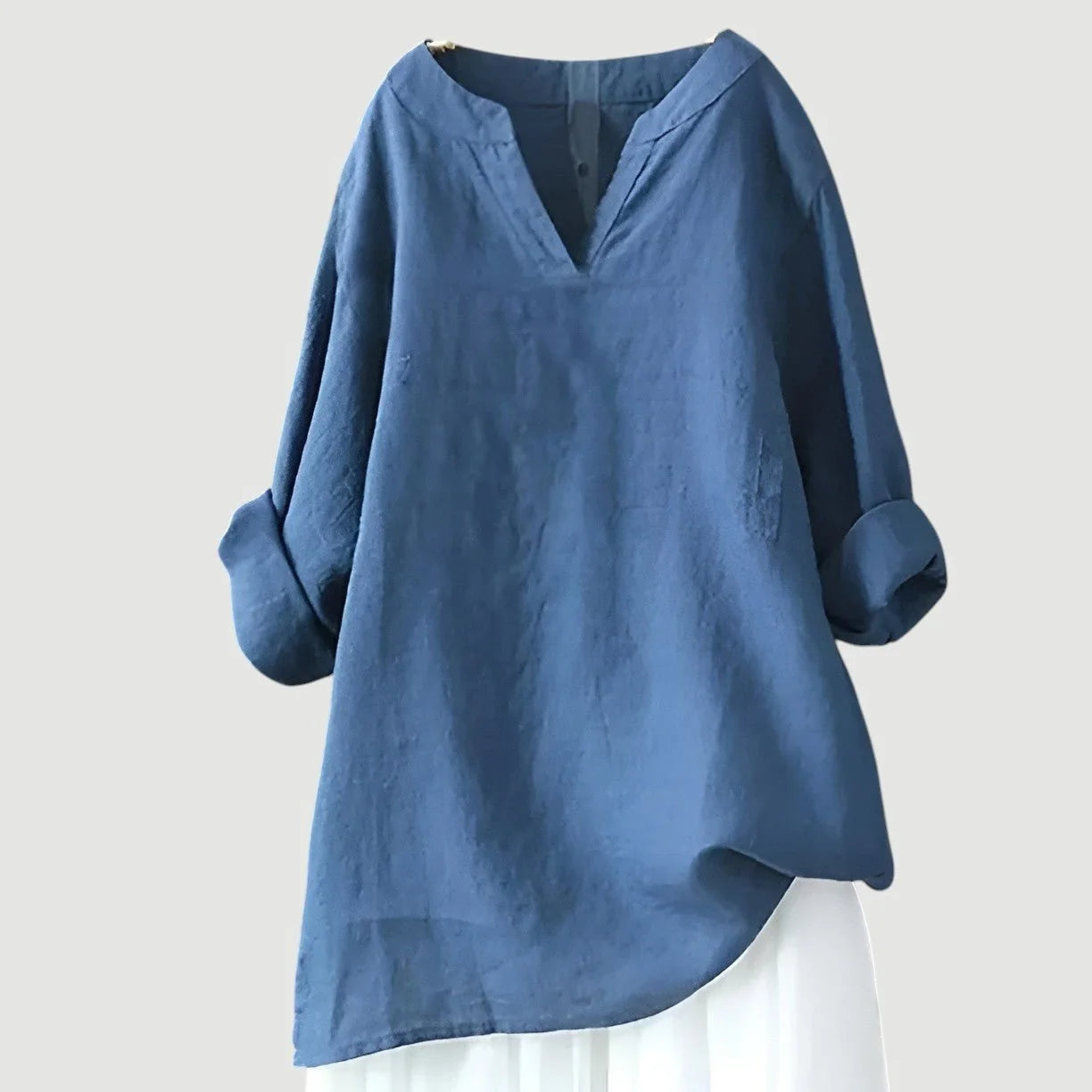 Women's V-neck tunic in blue with long sleeves and relaxed fit silhouette on neutral background