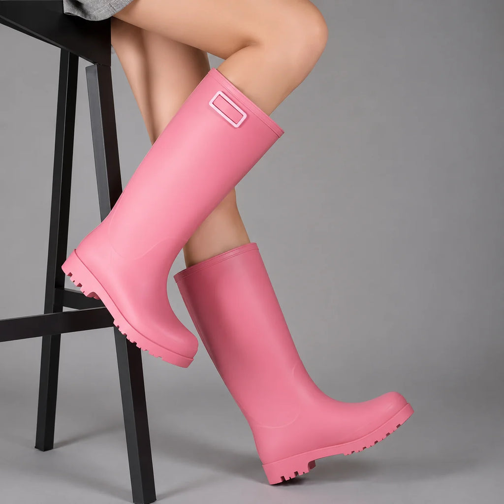Side view of pink women's wellington boots showing pull-on design with decorative buckle detail at cuff