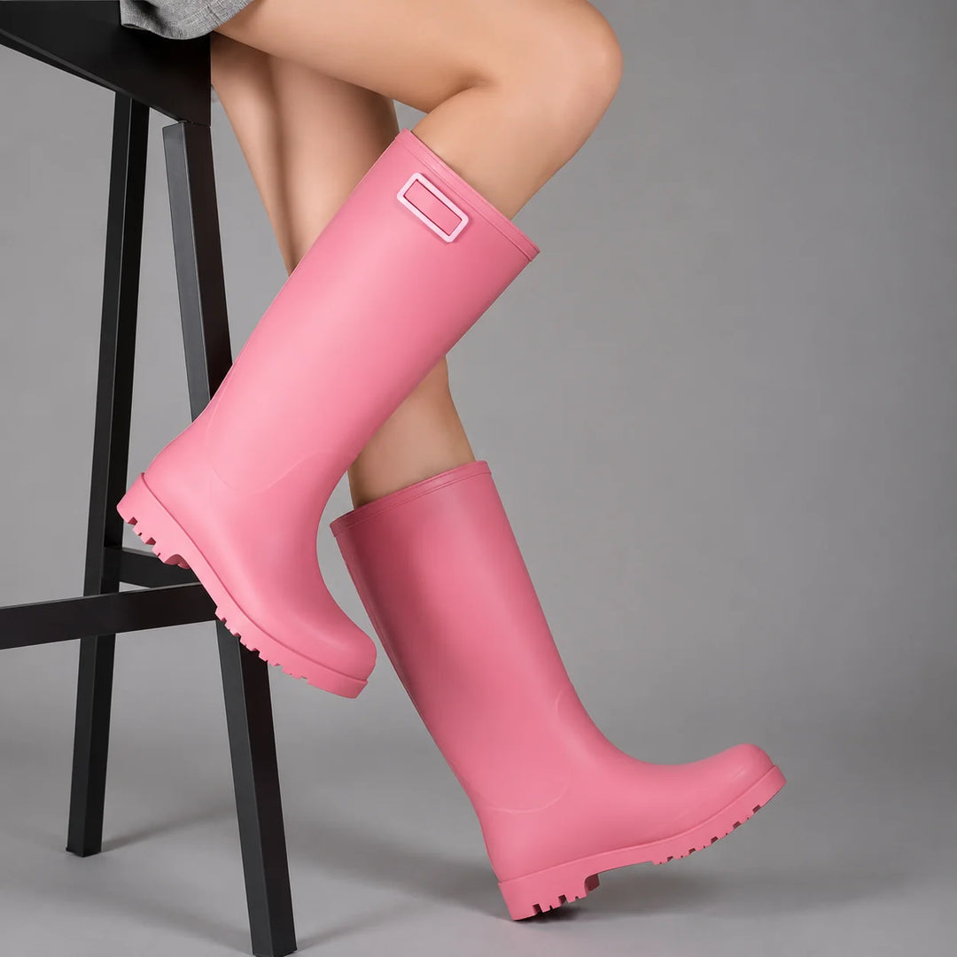 Side view of pink women's wellington boots showing pull-on design with decorative buckle detail at cuff