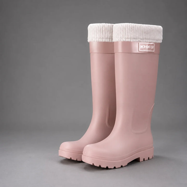 Detail of wellington boot cuff with white buckle accent and glossy waterproof finish for rainy days
