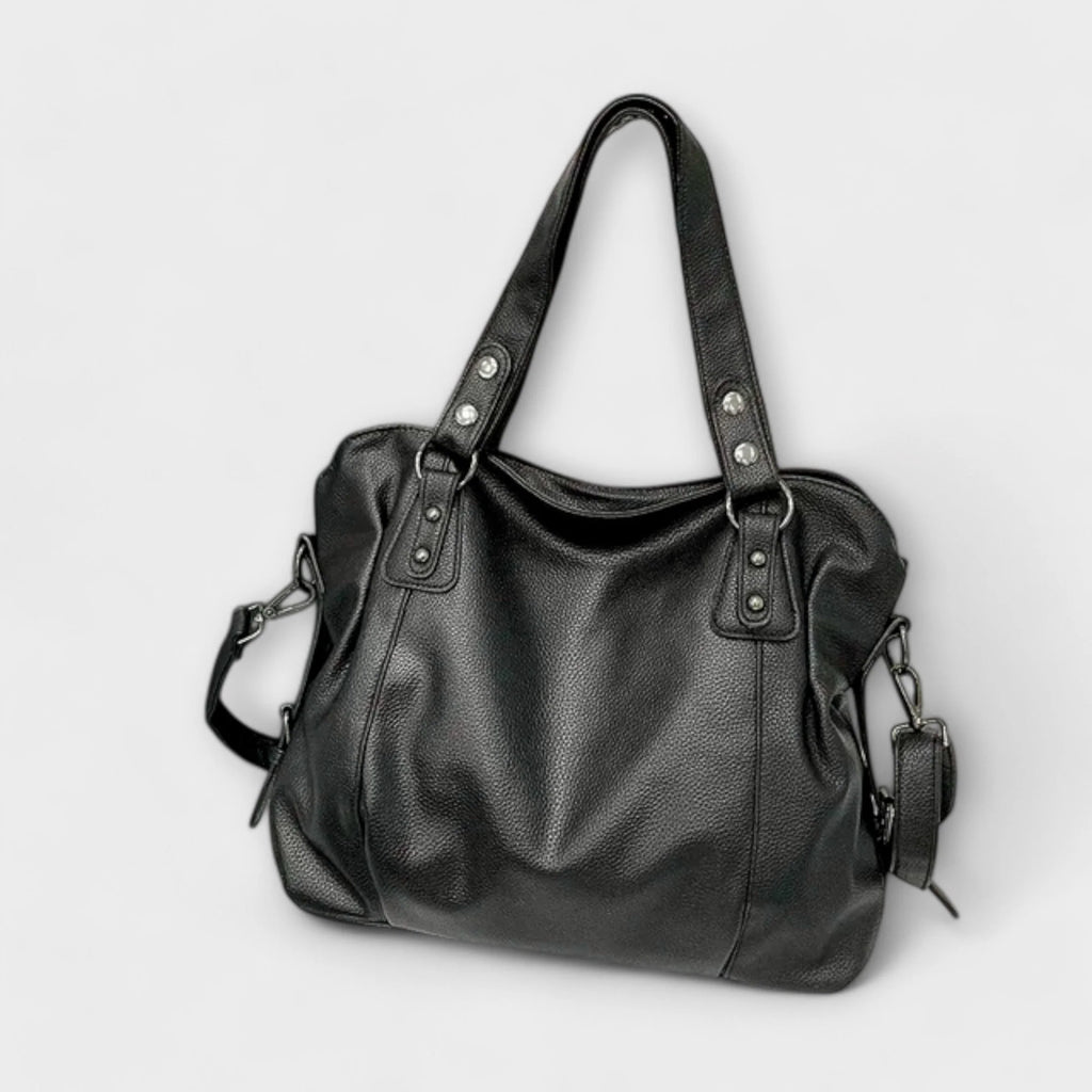 Hobo shoulder bag shown flat displaying full silhouette and studded handle design