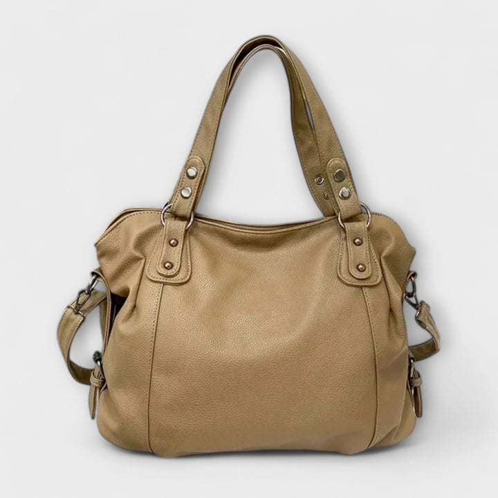 Angle view of hobo bag highlighting slouchy sides and flexible main compartment