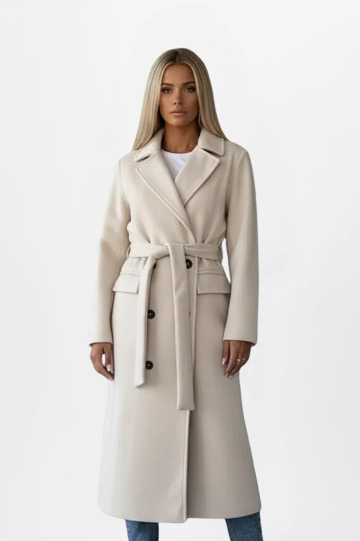 Women's belted trench coat in beige with double-breasted front and below-knee length on model
