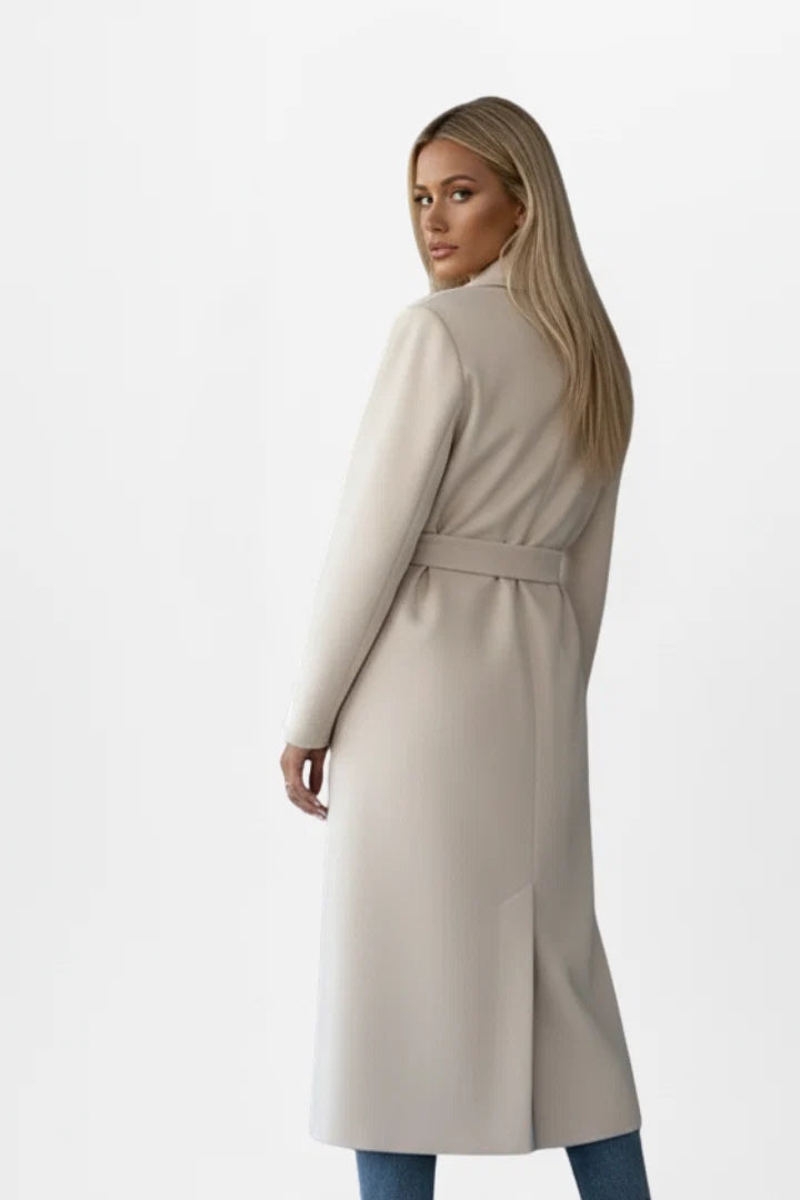 Close-up of double-breasted button closure and waist belt on women's trench coat