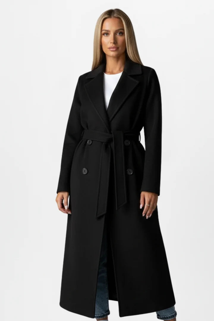 Women's belted trench coat in beige layered over white tee and denim for casual styling