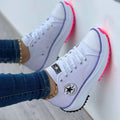 Women's chunky canvas trainers with bold platform sole and contrast stripe detail on feet