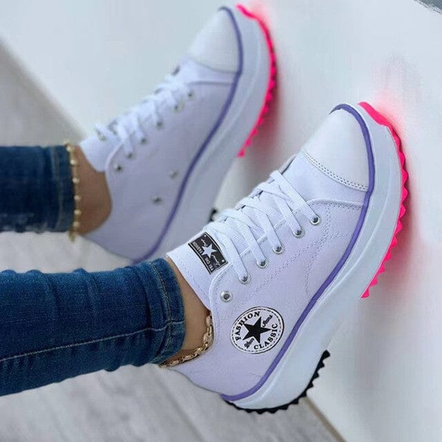 Women's chunky canvas trainers with bold platform sole and contrast stripe detail on feet