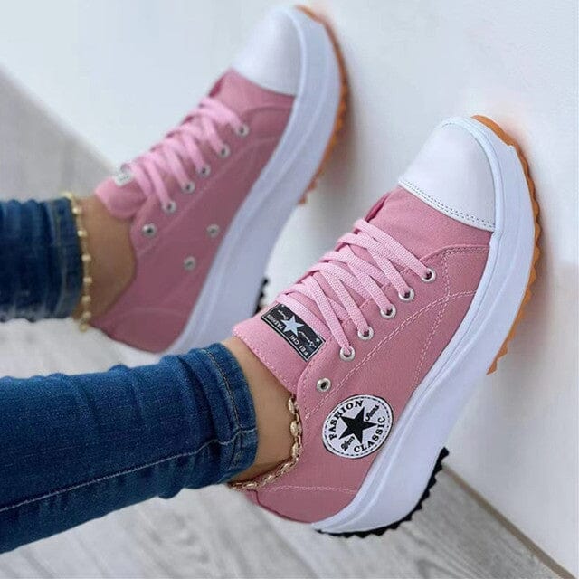 Close-up of women's chunky canvas trainers showing lace-up front and platform rubber sole