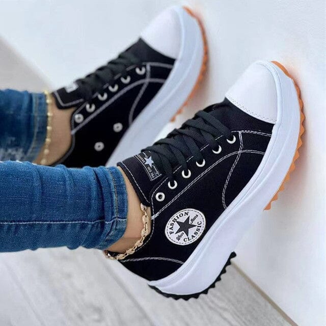 Side view of women's chunky canvas trainers highlighting contrast stripe and low-top silhouette