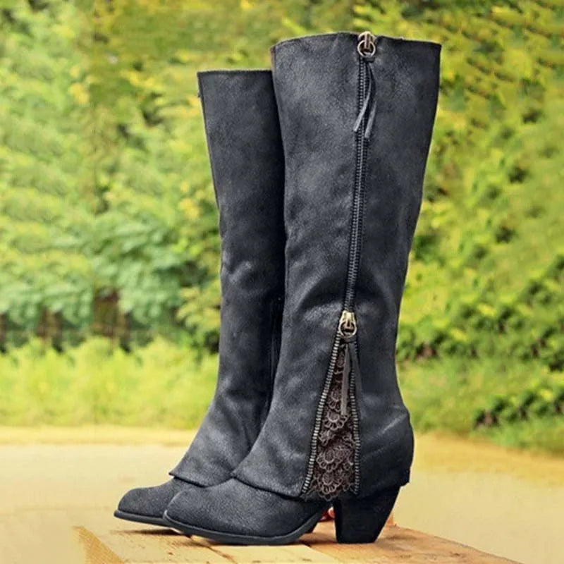 Side view of knee-high boots showing full-length zip and decorative lace panel with rounded toe