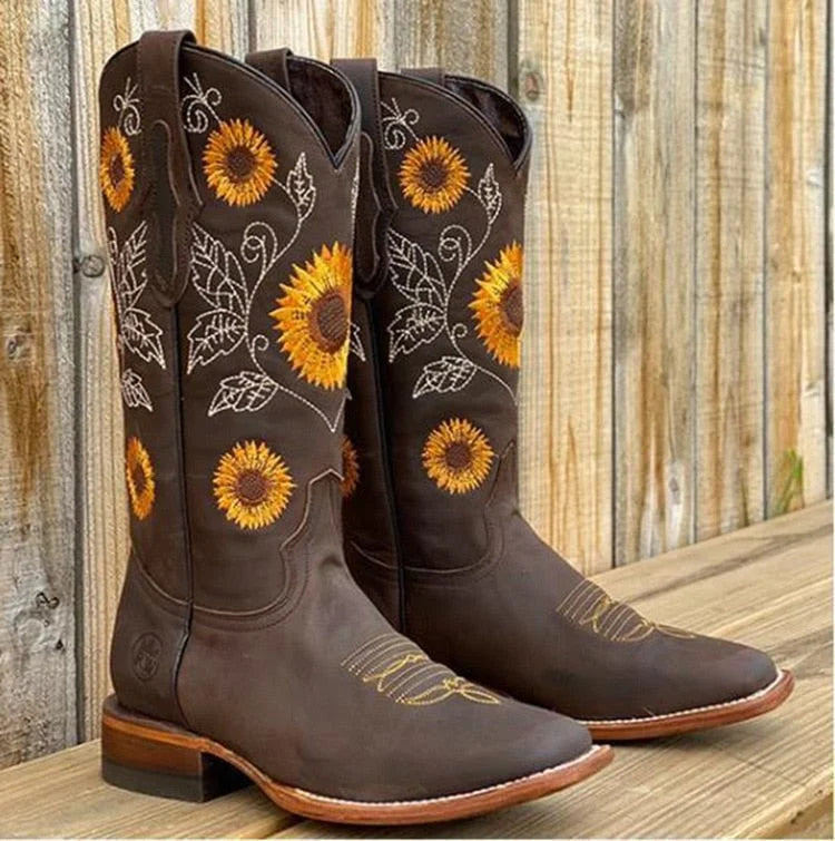 Detail shot of sunflower embroidery and Western stitching on women's mid-calf cowboy boots