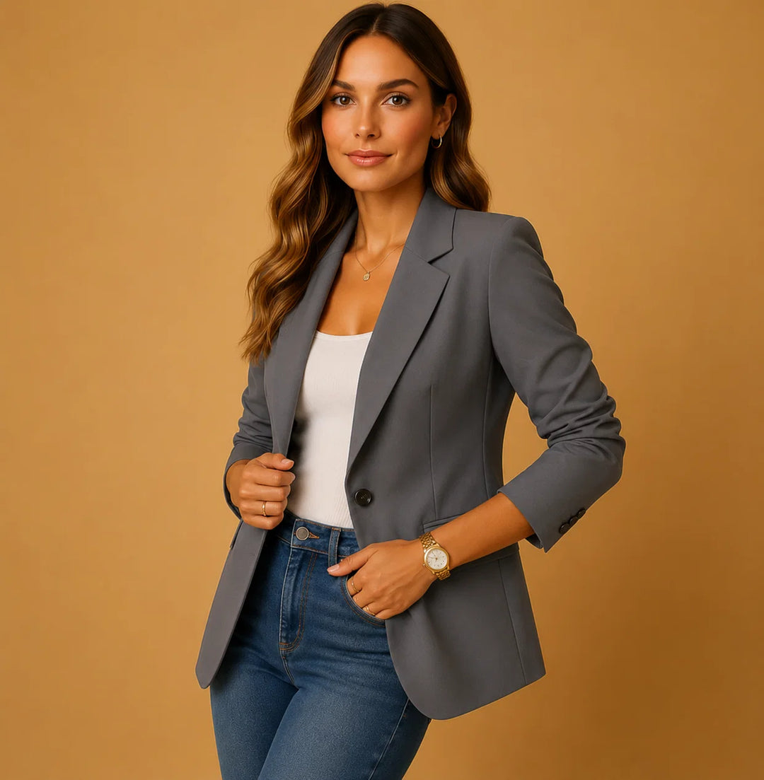 Women's fitted blazer layered over ribbed top showing sharp waist and shoulder structure