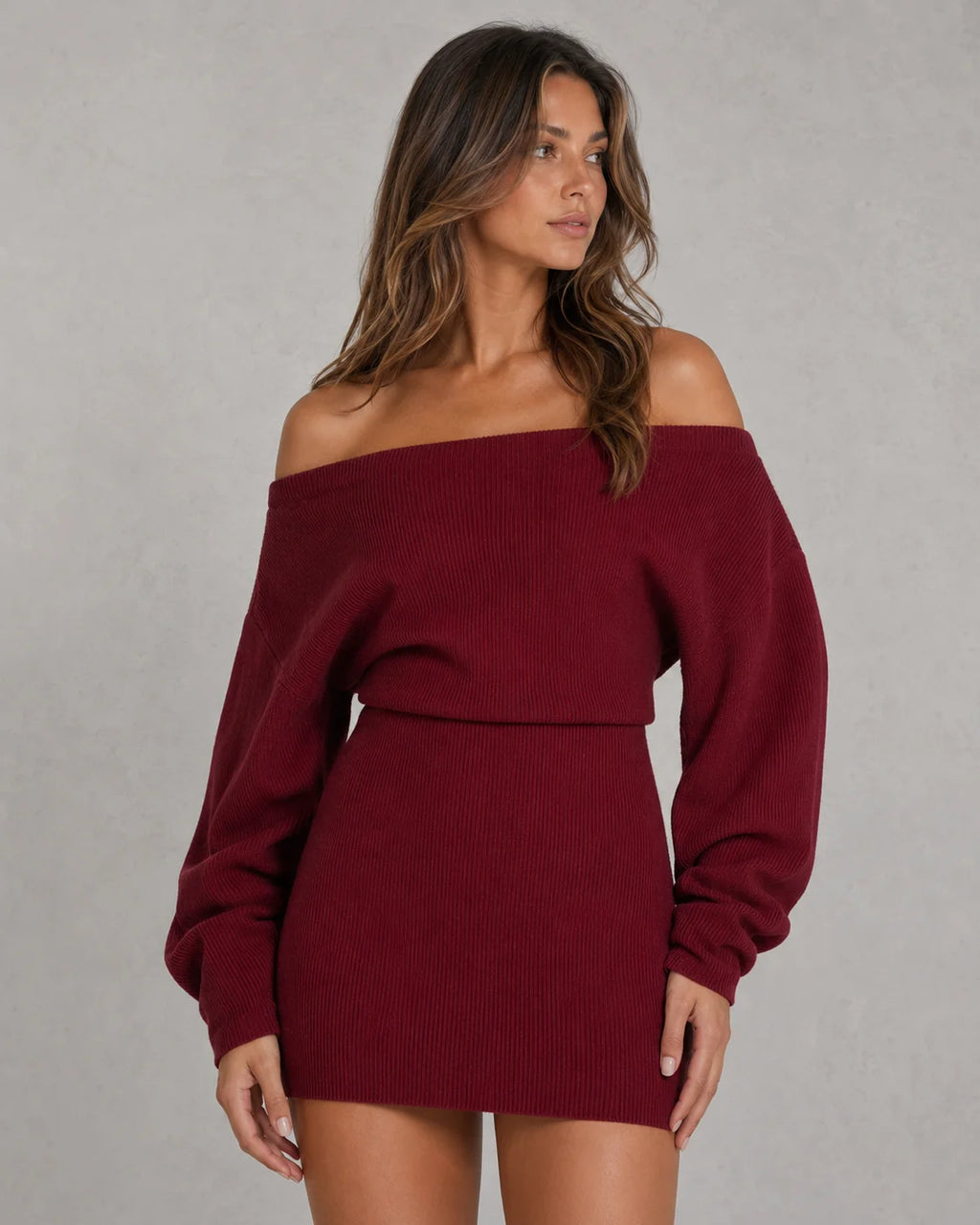 Woman styling off-shoulder knit mini dress for casual evening wear