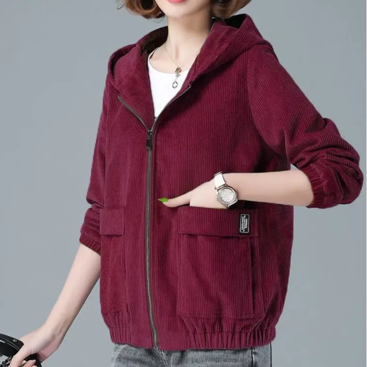 Women's rust corduroy jacket styled over casual outfit with denim