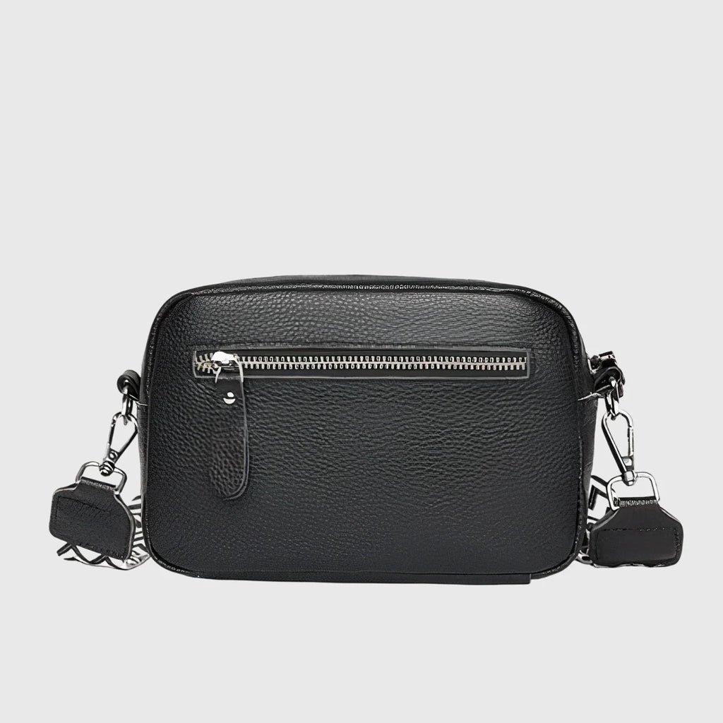 Close-up view of women's crossbody bag showing pebbled texture and front slip pocket detail