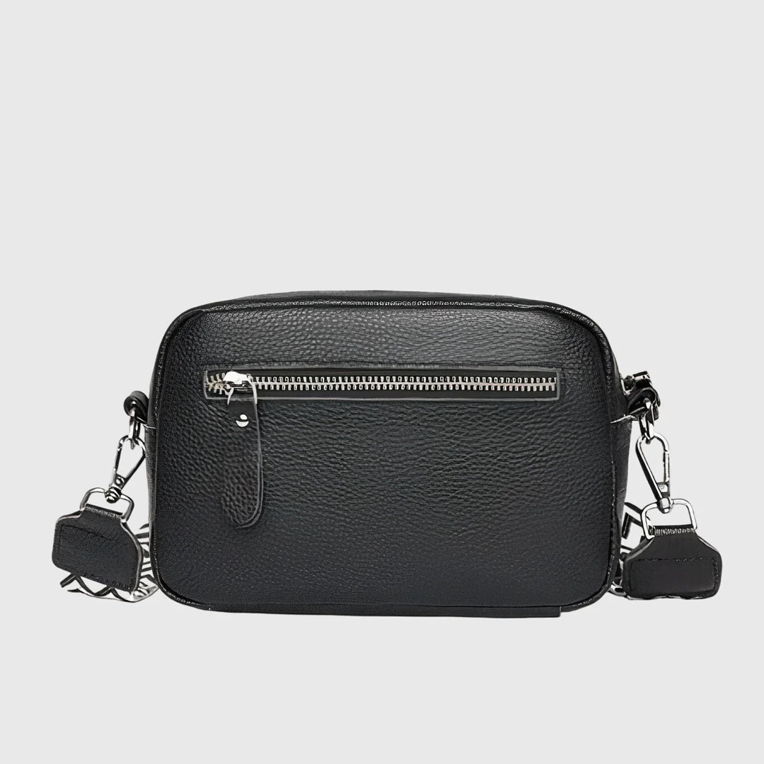 Close-up view of women's crossbody bag showing pebbled texture and front slip pocket detail