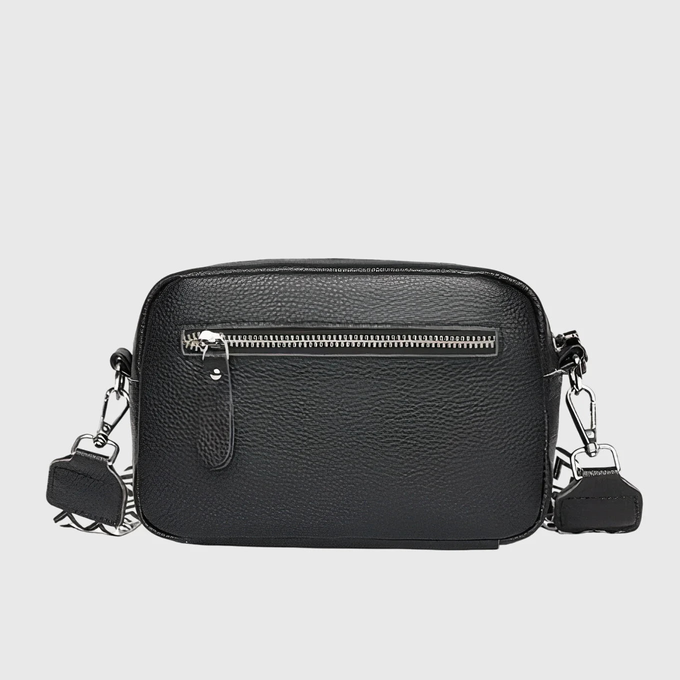 Close-up view of women's crossbody bag showing pebbled texture and front slip pocket detail