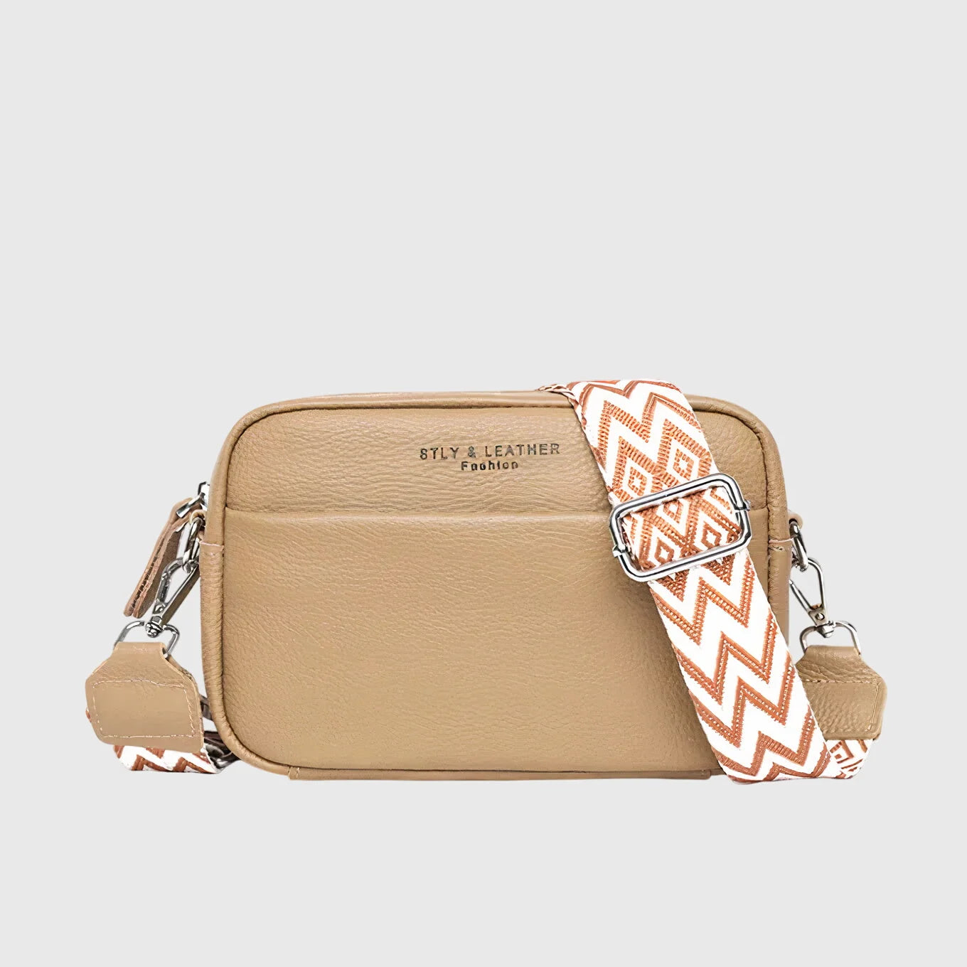 Rear view of textured crossbody bag showing structured shape and adjustable shoulder strap attachment