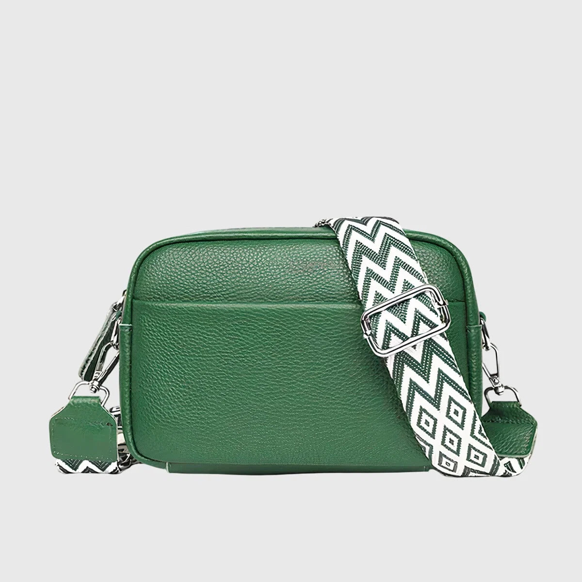 Detail shot of crossbody bag zip closure and front pocket with embossed branding