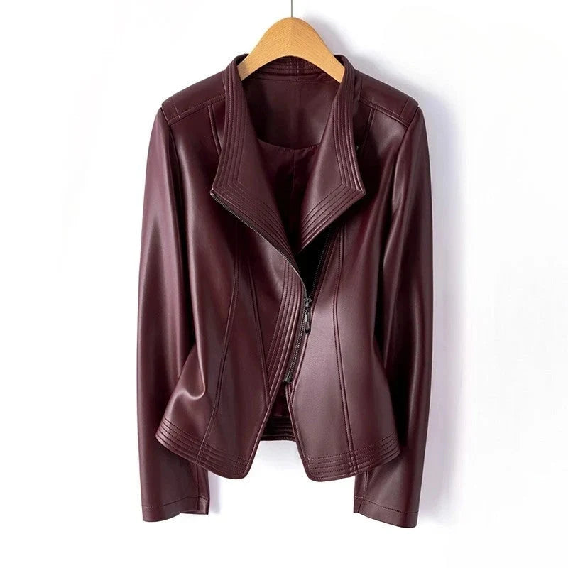 Women's burgundy leather biker jacket with asymmetric zip and notched collar on wooden hanger