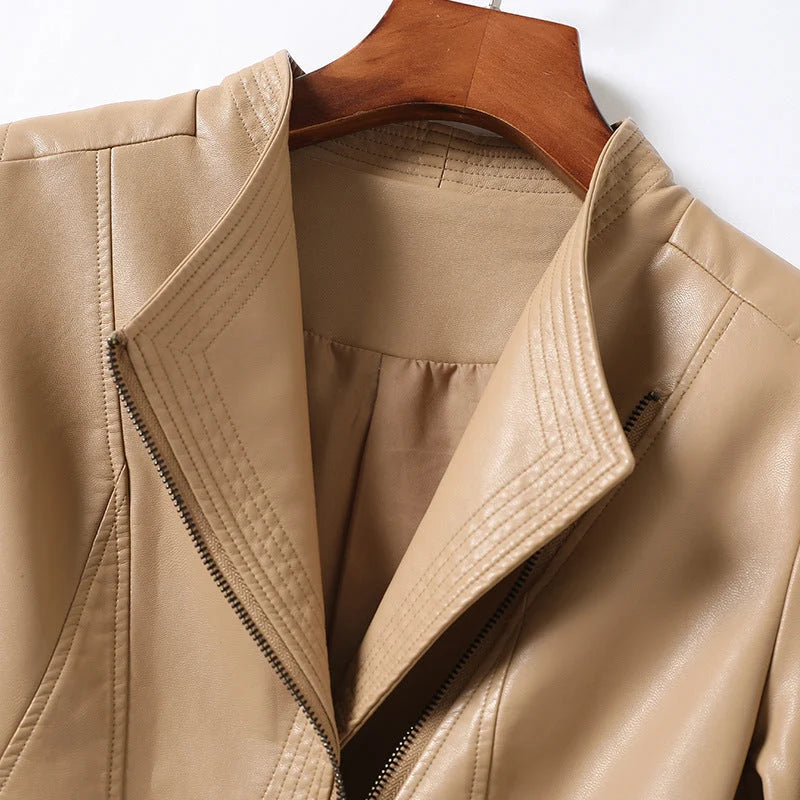 Women's faux leather jacket showing smooth finish and tailored silhouette on hanger