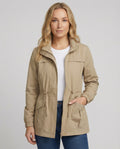 Women's utility jacket with drawstring waist and stand collar in khaki beige worn casually